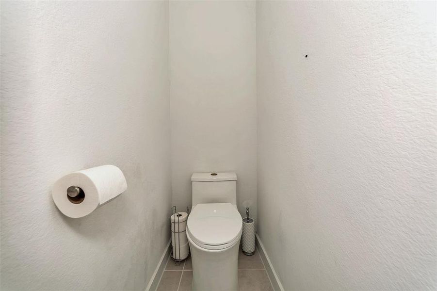 Bathroom featuring toilet and tile patterned floors