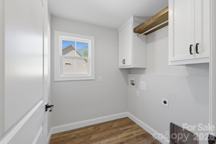 well-appointed laundry room with a dedicated hanging rod for everyday ease