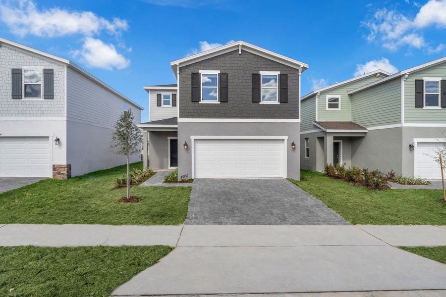Front exterior of a new home in Oakfield Trails, Parrish, FL, highlighting curb appeal (Image 20). Front exterior of a new home in Oakfield Trails, Parrish, FL, highlighting curb appeal (Image 20).