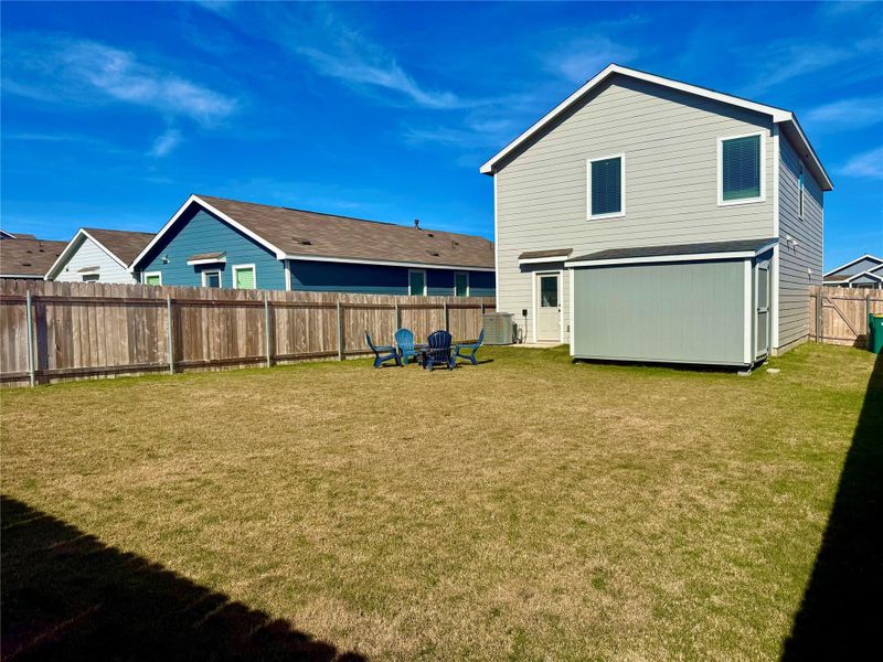 Rear view of property with a fenced backyard