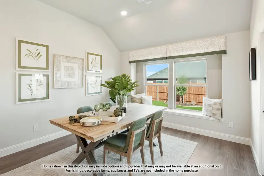 Dining area with wood table, green chairs, window seat, and vaulted ceiling
