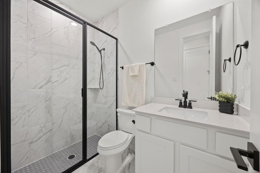 Full bathroom with vanity, a marble finish shower, and marble finish floors