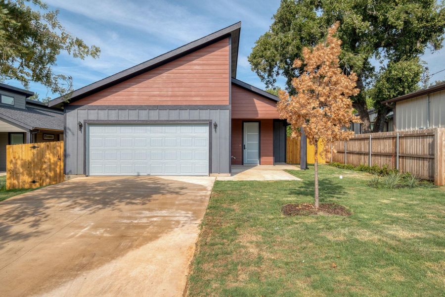 View of front of property featuring driveway, a porch, and a garage View of front of property featuring driveway, a porch, and a garage