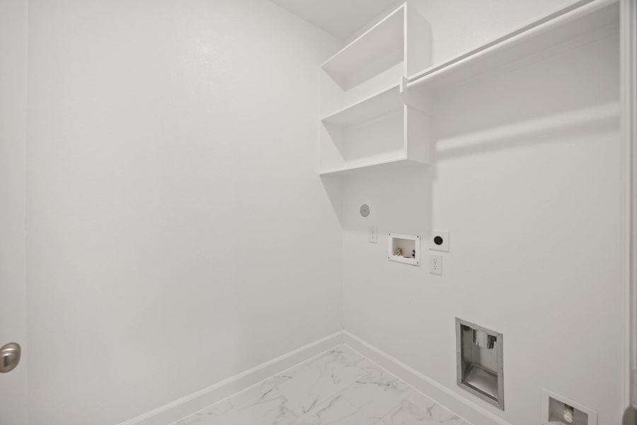 Located on the second floor, the laundry room offers convenience with space for side-by-side washer and dryer, complemented by hang and shelf space and an additional closed (not pictured) Located on the second floor, the laundry room offers convenience with space for side-by-side washer and dryer, complemented by hang and shelf space and an additional closed (not pictured)