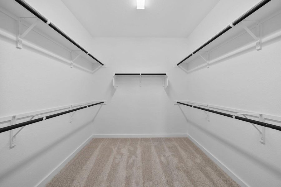 Walk-in closet in Primary Bedroom Walk-in closet in Primary Bedroom