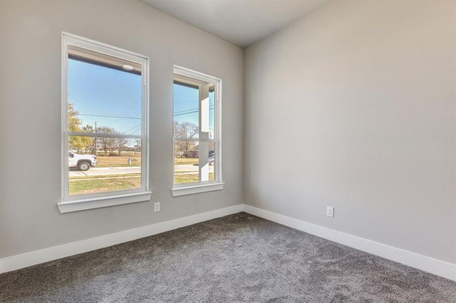 Unfurnished room featuring baseboards and carpet floors