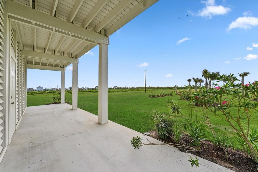 Ground-level patio with lush landscaping and serene open views—ideal for morning coffee or evening unwinding. Ground-level patio with lush landscaping and serene open views—ideal for morning coffee or evening unwinding.