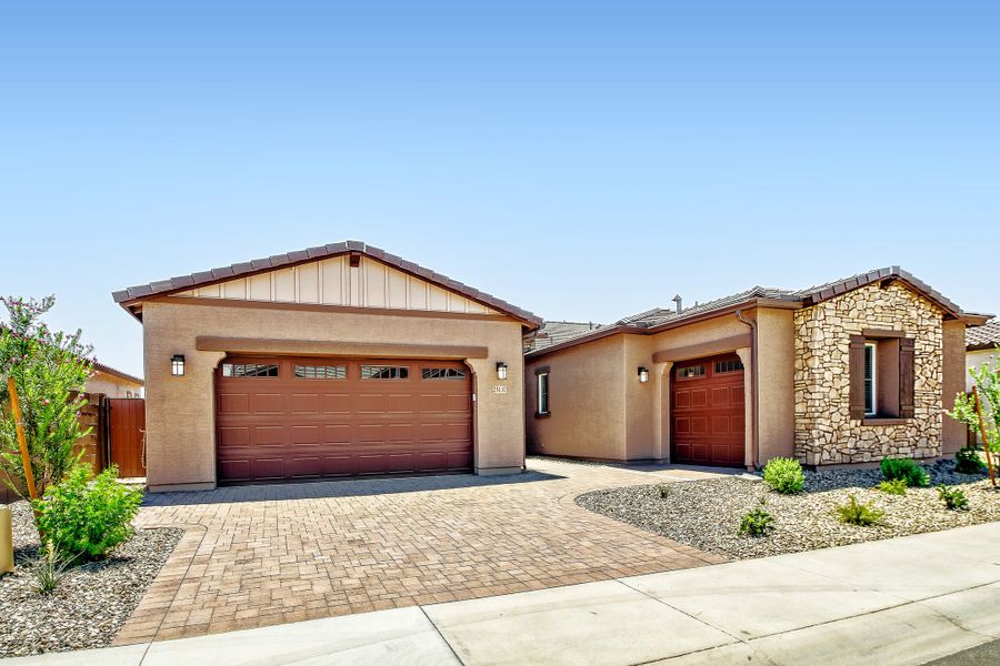 Front exterior of a new home in Asante Heritage | Active Adult, Surprise, AZ, highlighting curb appeal (Image 1). Front exterior of a new home in Asante Heritage | Active Adult, Surprise, AZ, highlighting curb appeal (Image 1).