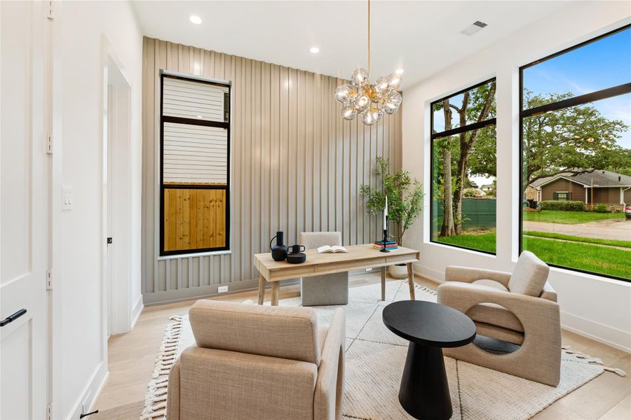 Glass French doors lead to the home office which features abundant natural light, complemented by the convenience of a private full bathroom and walk-in closet. This workspace doubles as an elegant guest bedroom, providing both functionality and privacy.