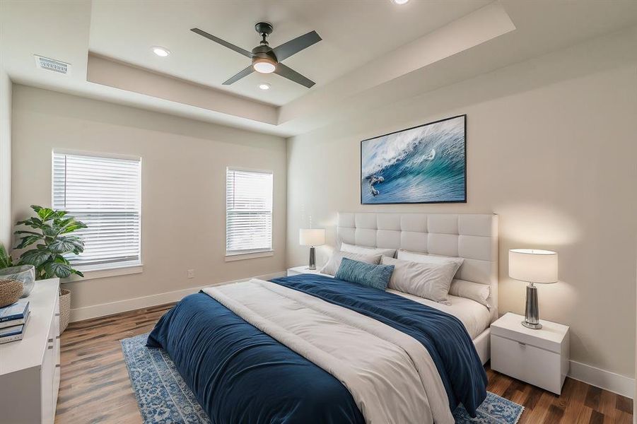 Primary Bedroom with ceiling fan, dark hardwood / wood-style floors, a raised ceiling, and multiple windows
virtually staged