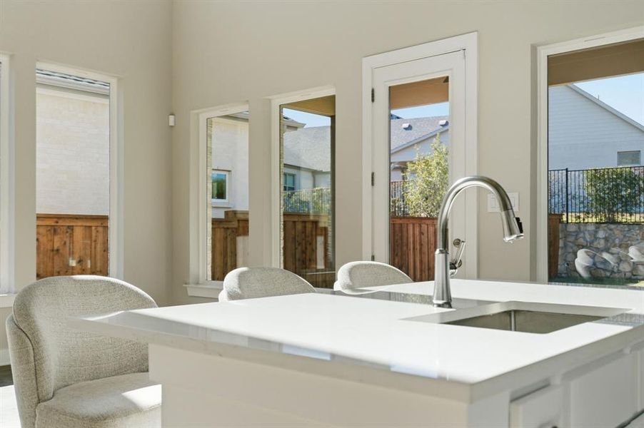 Kitchen featuring a sink and light countertops