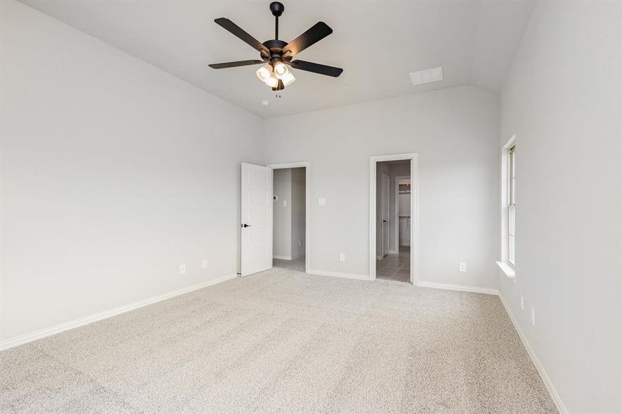 Unfurnished bedroom featuring light carpet and ceiling fan