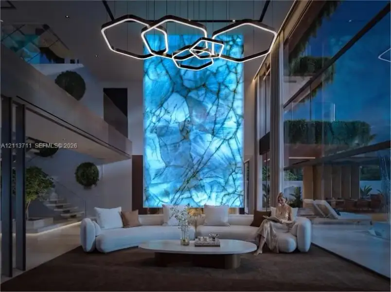 Double-height living area featuring an illuminated floor-to-ceiling stone accent wall, geometric multi-tier pendant lighting, expansive glass wall panels, and a floating staircase