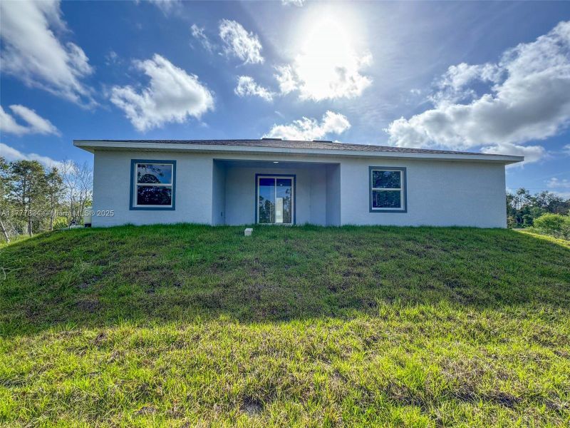 Front exterior of a new home in , Lehigh Acres, FL, highlighting curb appeal (Image 13). Front exterior of a new home in , Lehigh Acres, FL, highlighting curb appeal (Image 13).