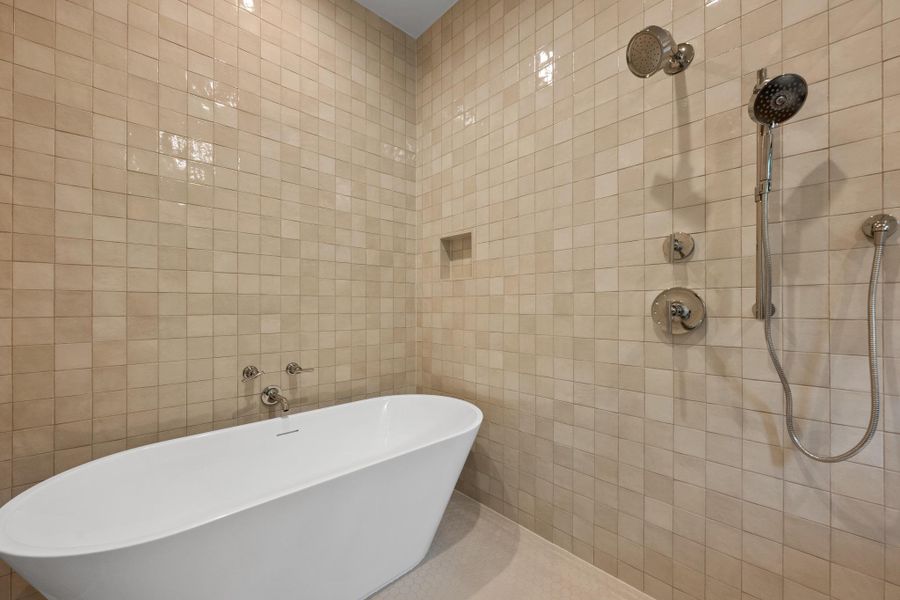 Indulge in relaxation with this elegant freestanding tub and sleek shower system. Indulge in relaxation with this elegant freestanding tub and sleek shower system.