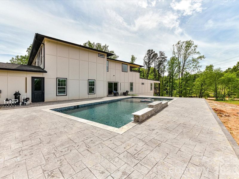 Spacious outdoor patio with an in-ground pool and spa, offering a great opportunity to customize your dream backyard retreat.