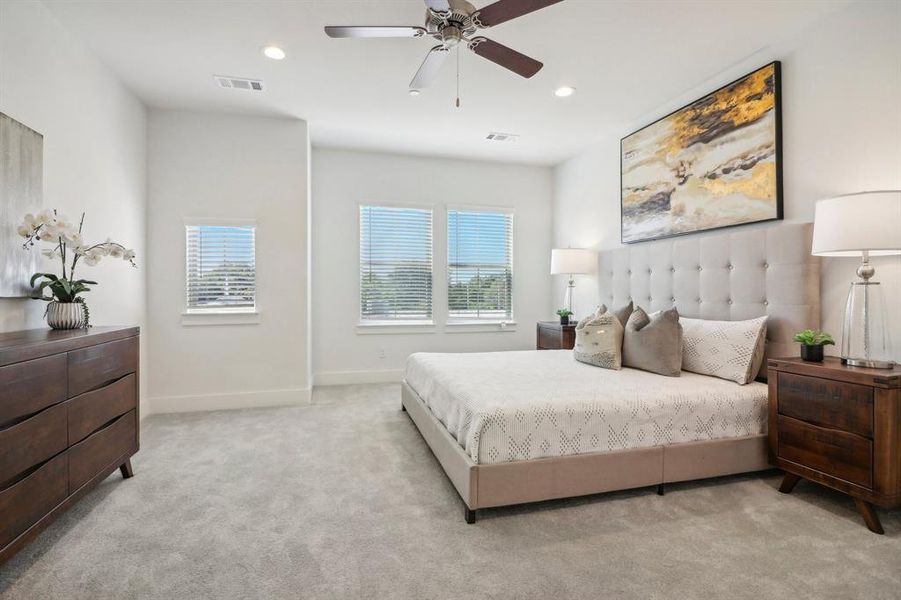 Carpeted bedroom with ceiling fan