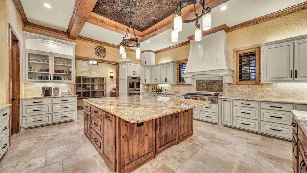 Oversized central island anchors the kitchen, offering plenty of prep space and a natural gathering spot.