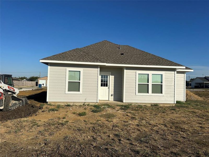 Rear view of property featuring roof with shingles Rear view of property featuring roof with shingles