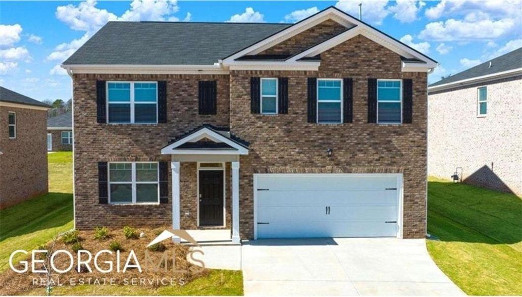 Front exterior of a new home in The Reserve at Calcutta, Stockbridge, GA, highlighting curb appeal (Image 31).