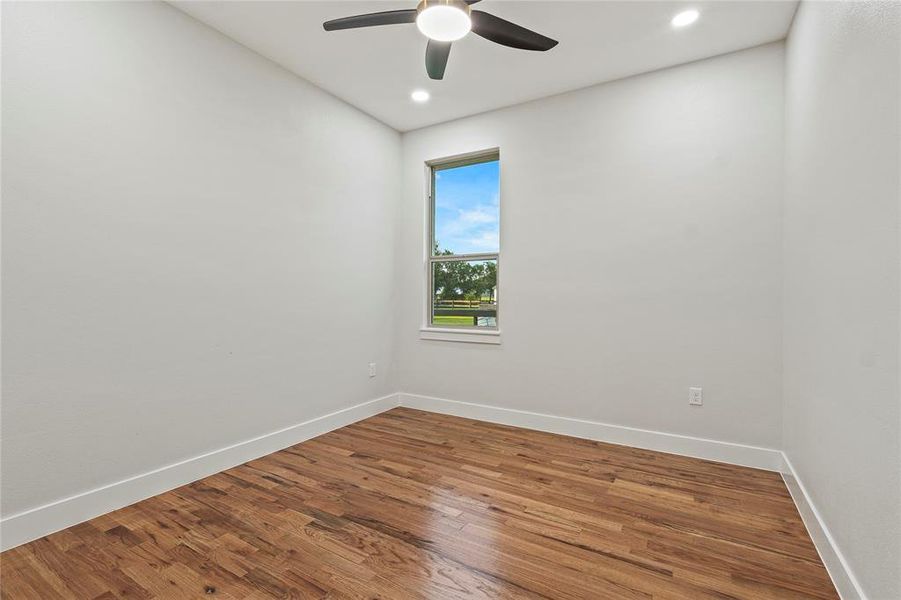 Empty room with ceiling fan, wood finished floors, and recessed lighting Empty room with ceiling fan, wood finished floors, and recessed lighting