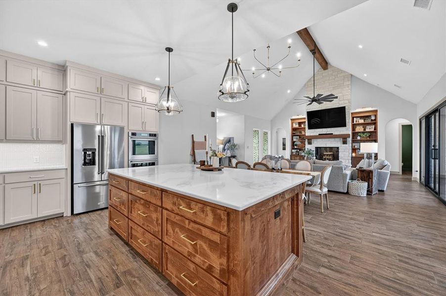 Gourmet kitchen island with wood-finish cabinetry and a light-toned countertop