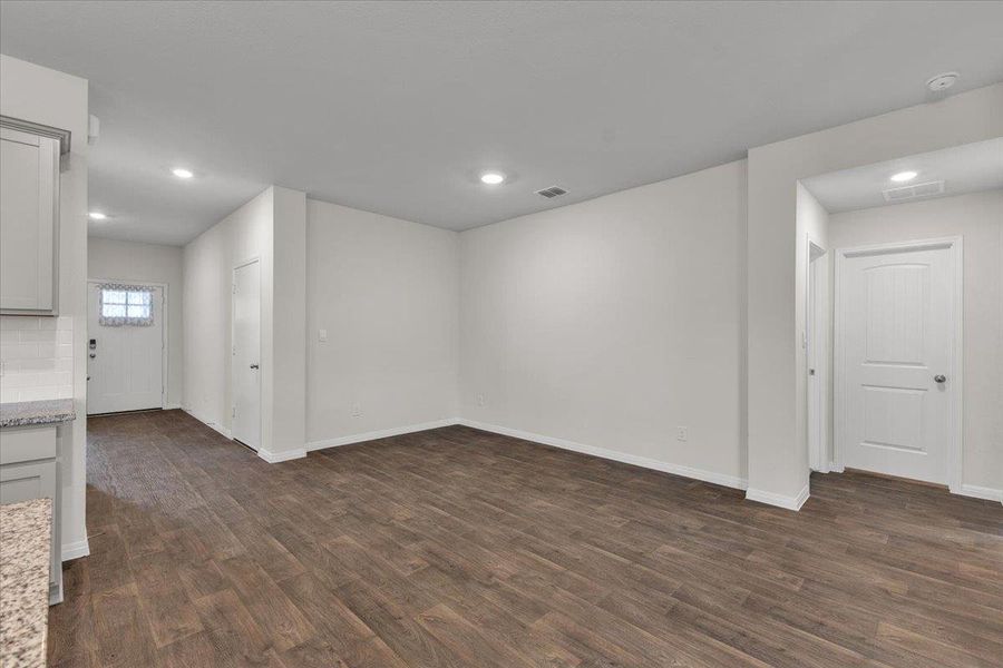 The property features plank-style flooring, recessed lighting, and crisp white walls throughout