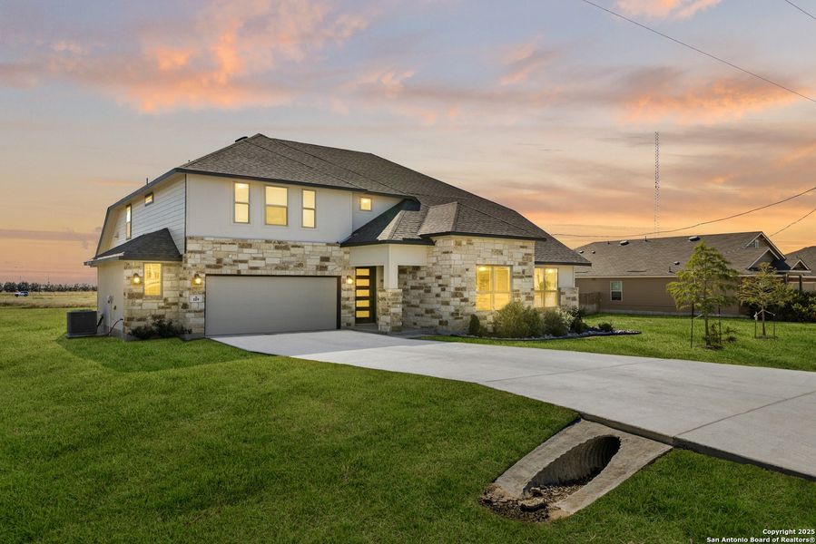Front exterior of a new home in Arched Oaks, Floresville, TX, highlighting curb appeal (Image 1). Front exterior of a new home in Arched Oaks, Floresville, TX, highlighting curb appeal (Image 1).