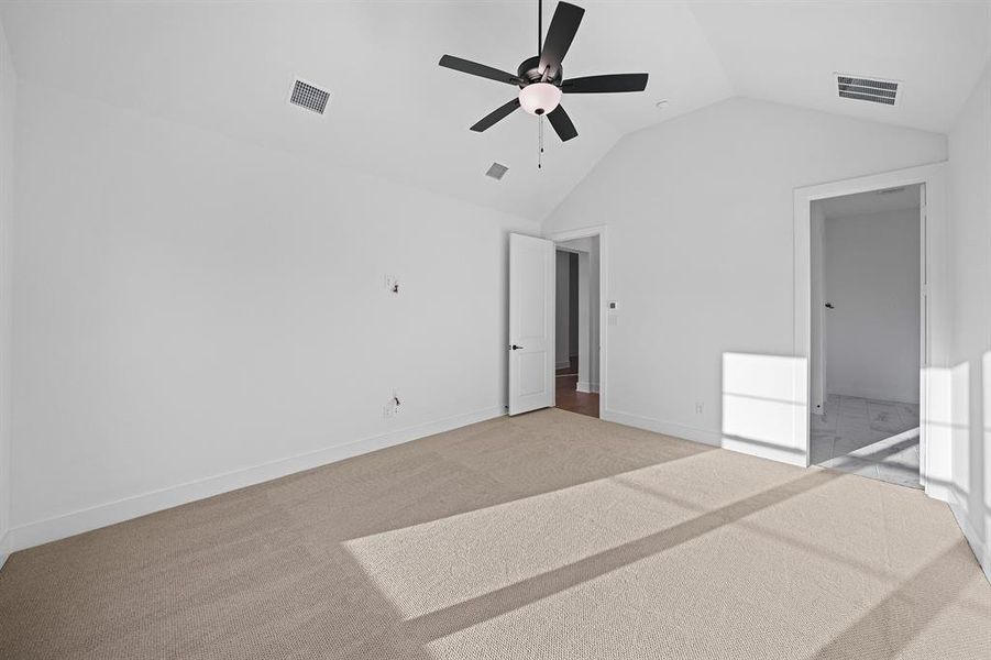 Unfurnished bedroom with carpet floors, ceiling fan, and high vaulted ceiling Unfurnished bedroom with carpet floors, ceiling fan, and high vaulted ceiling