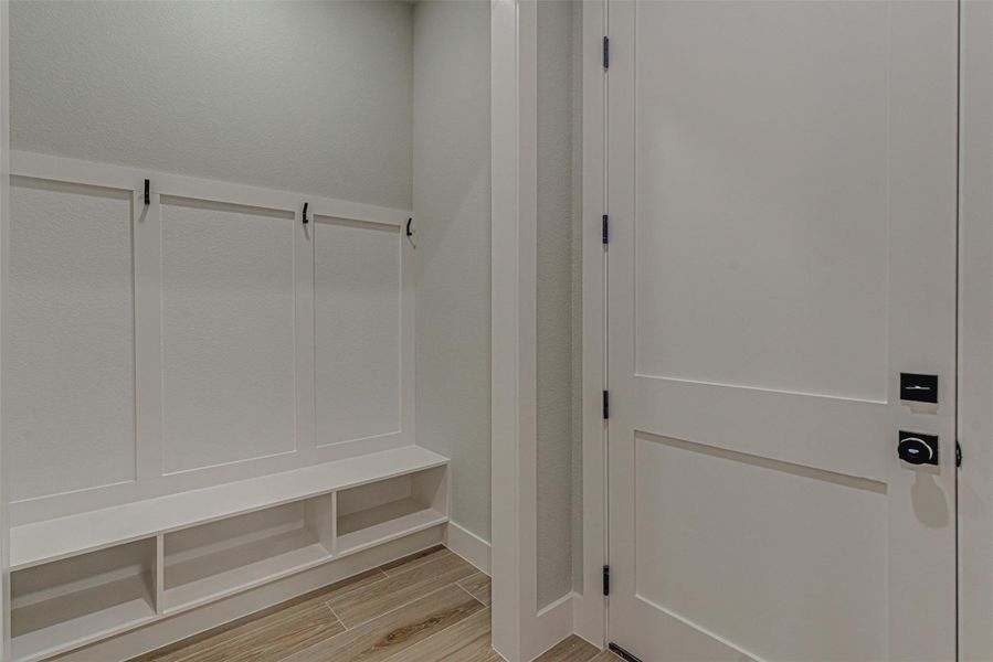 Mudroom with tile wood-type flooring.