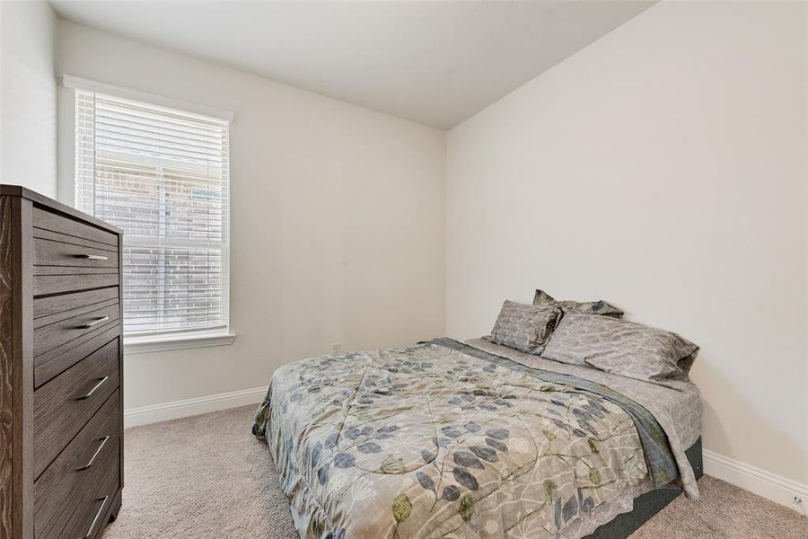 Bedroom featuring light colored carpet Bedroom featuring light colored carpet