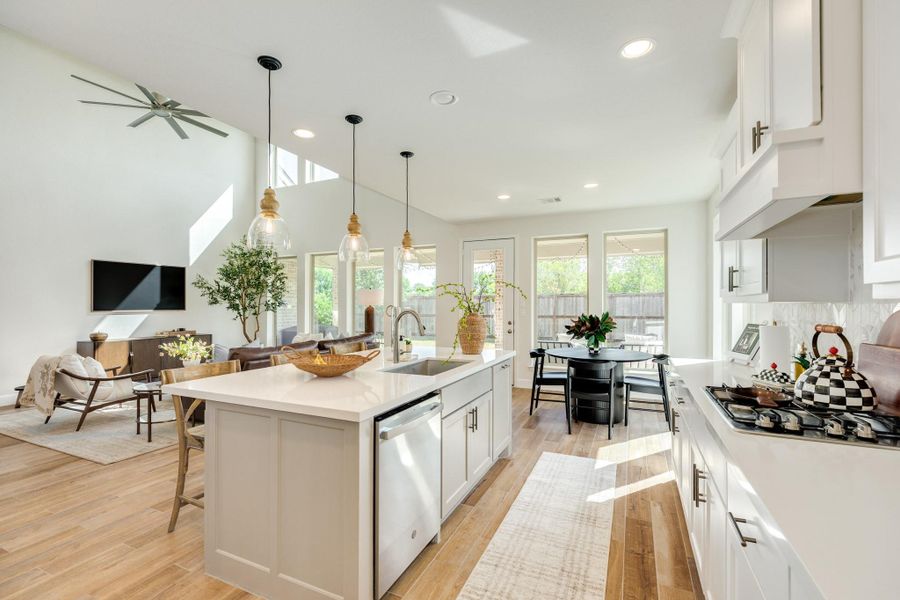 Spacious kitchen featuring an abundance of cabinet storage, premium stainless steel appliances, modern hardware, and an a designer fauce Spacious kitchen featuring an abundance of cabinet storage, premium stainless steel appliances, modern hardware, and an a designer fauce