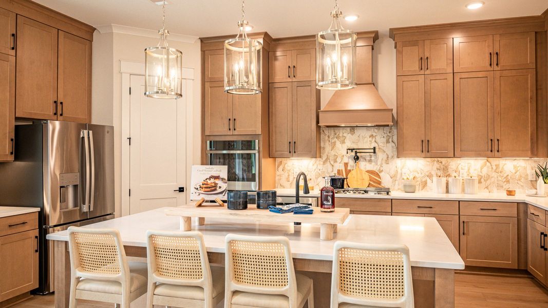 Full kitchen layout with large extended island and beautiful ceiling height cabinetry