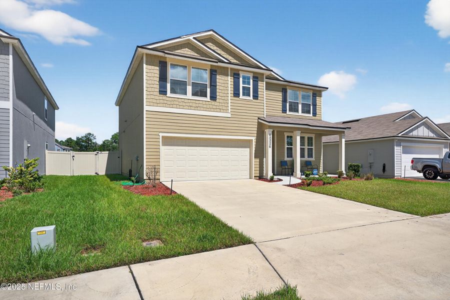Front exterior of a new home in River Glen Express, Yulee, FL, highlighting curb appeal (Image 2).