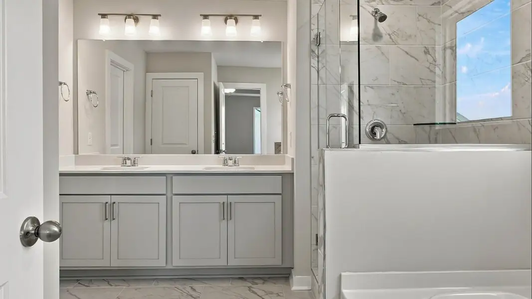 Relaxing bathroom features such as separate bathtub and shower paired with dual vanities Relaxing bathroom features such as separate bathtub and shower paired with dual vanities