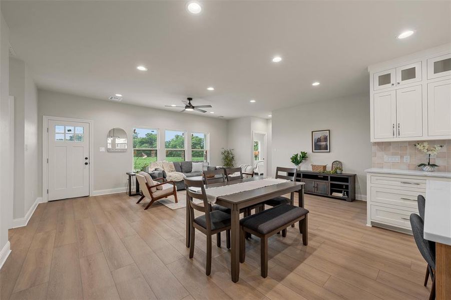 Open-concept living area featuring wood-finish flooring, recessed lighting, and a ceiling fan