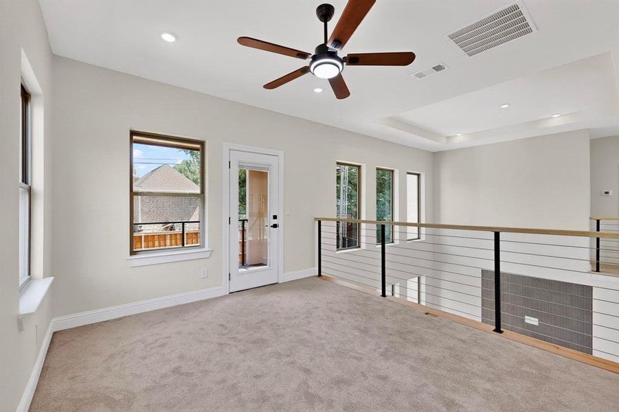 Carpeted empty room with ceiling fan, recessed lighting, and a raised ceiling Carpeted empty room with ceiling fan, recessed lighting, and a raised ceiling