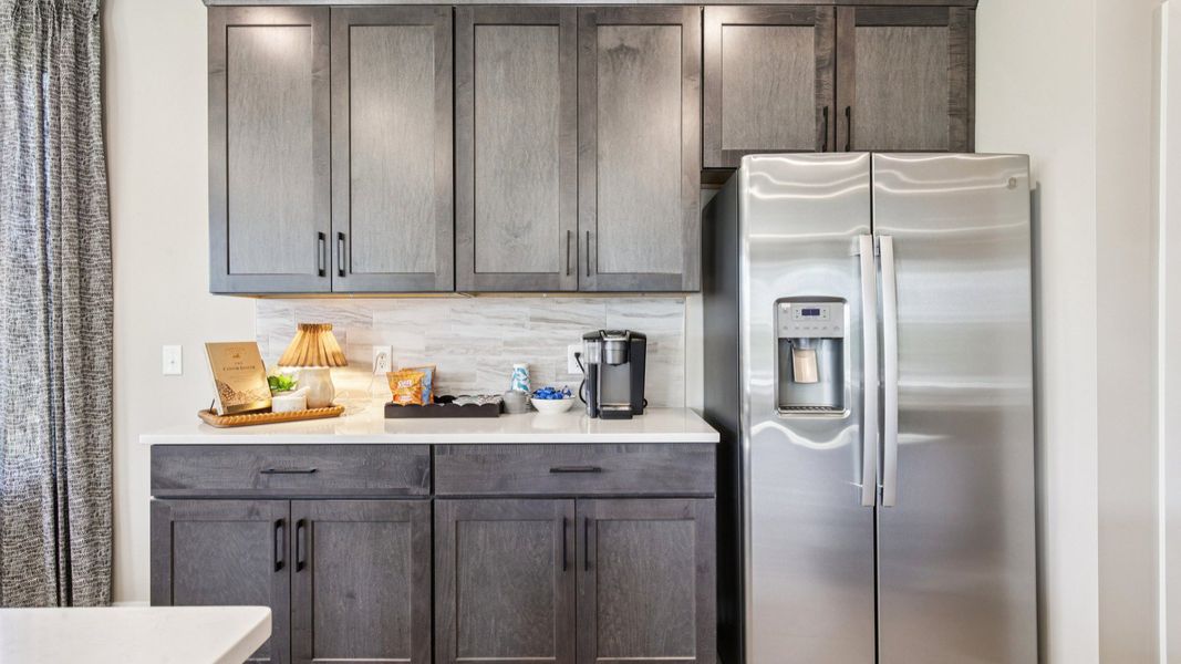 Kitchen with quartz countertops and dark cabinetry