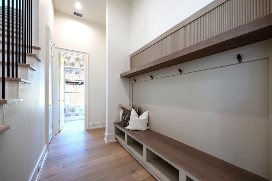 Conveniently located by the garage door, the mudroom serves as the perfect drop zone to help the rest of the house to remain organized and clutter free.