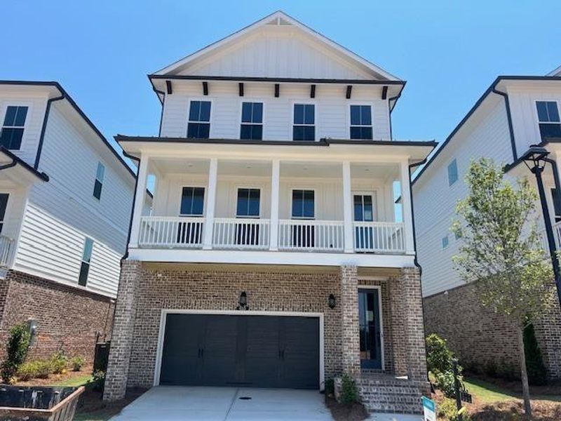 Front exterior of a new home in Palisades Single Family, Cumming, GA, highlighting curb appeal (Image 27).