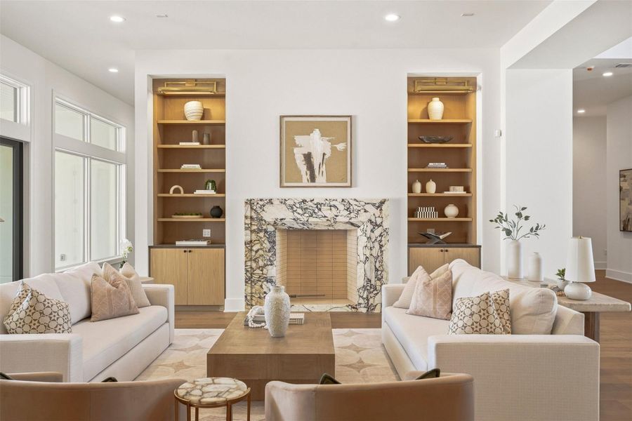 Custom built-in wood shelves flank the fireplace and large sliding glass doors allow for ample natural light. Custom built-in wood shelves flank the fireplace and large sliding glass doors allow for ample natural light.