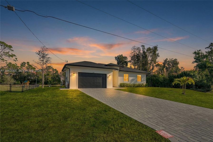 Front exterior of a new home in , Lehigh Acres, FL, highlighting curb appeal (Image 22).