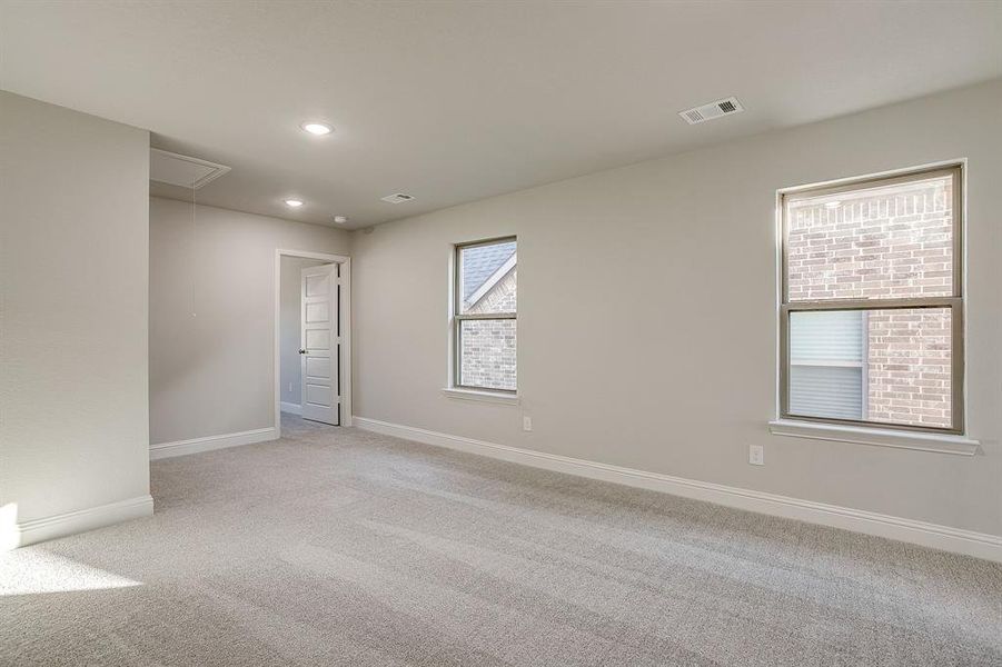 Unfurnished room featuring light carpet and recessed lighting Unfurnished room featuring light carpet and recessed lighting