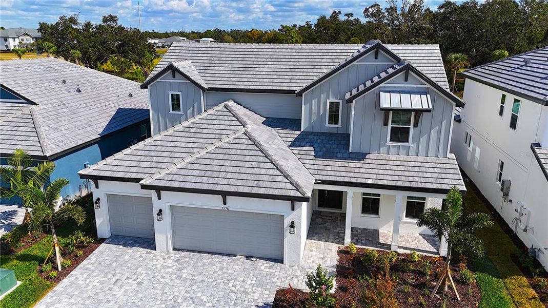 Front exterior of a new home in Hawkstone, Sarasota, FL, highlighting curb appeal (Image 1).