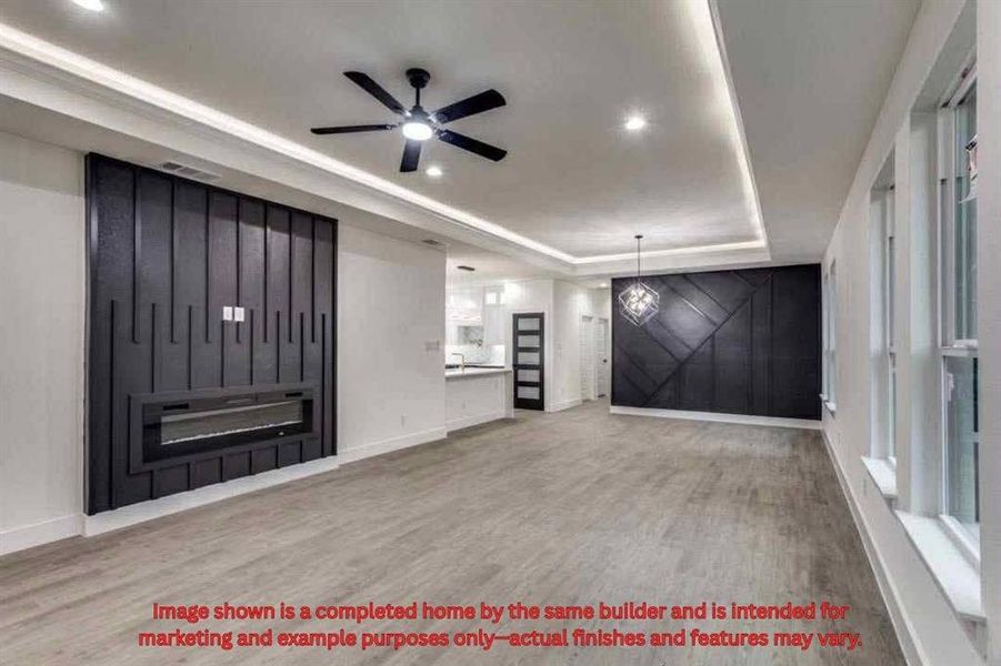 Foyer entrance with a barn door, a tray ceiling, light wood-type flooring, ceiling fan, and recessed lighting Foyer entrance with a barn door, a tray ceiling, light wood-type flooring, ceiling fan, and recessed lighting