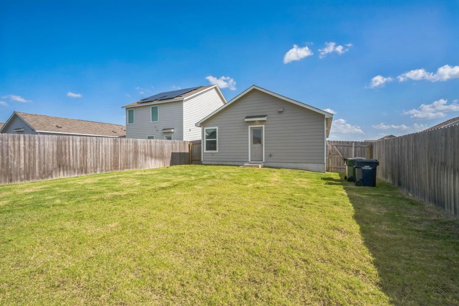 A fully fenced backyard with ample lawn space for outdoor enjoyment. A fully fenced backyard with ample lawn space for outdoor enjoyment.