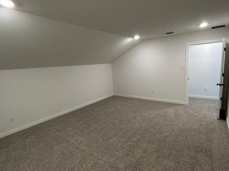 Bonus room with carpet flooring, lofted ceiling, and recessed lighting Bonus room with carpet flooring, lofted ceiling, and recessed lighting