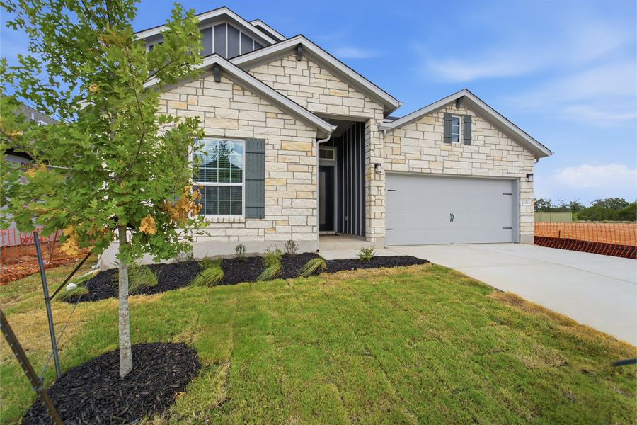 Front exterior of a new home in Santa Rita Ranch, Liberty Hill, TX, highlighting curb appeal (Image 2).