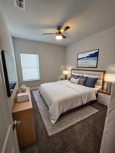 Bedroom with ceiling fan and carpet floors