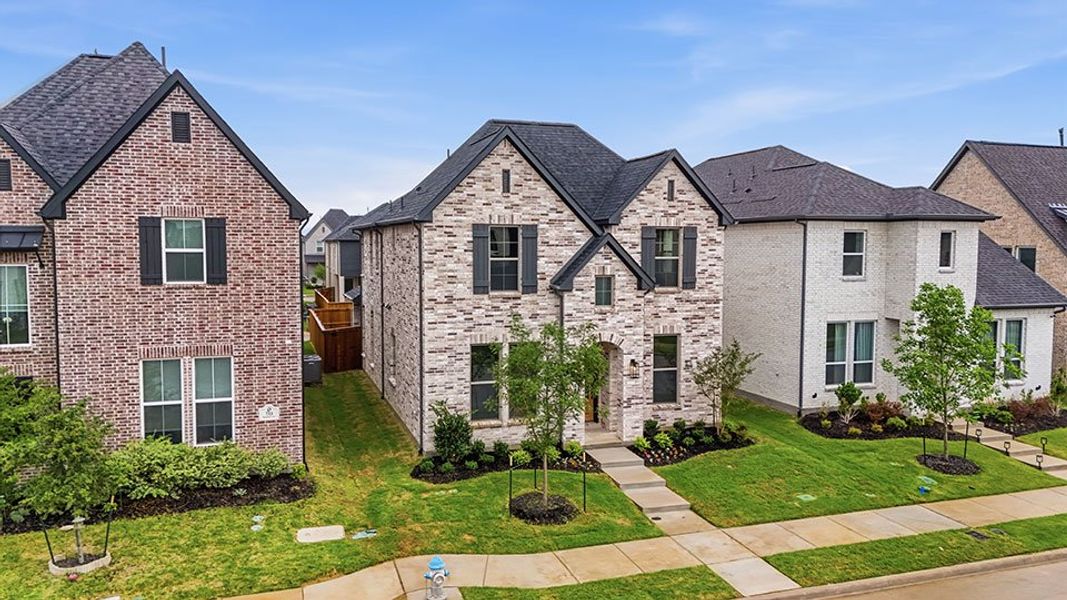 Front exterior of a new home in Light Farms Brenham - 40' Lots, Celina, TX, highlighting curb appeal (Image 29). Front exterior of a new home in Light Farms Brenham - 40' Lots, Celina, TX, highlighting curb appeal (Image 29).
